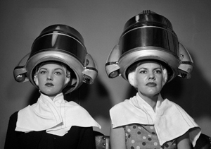 Photo of two ladies under hair dryers